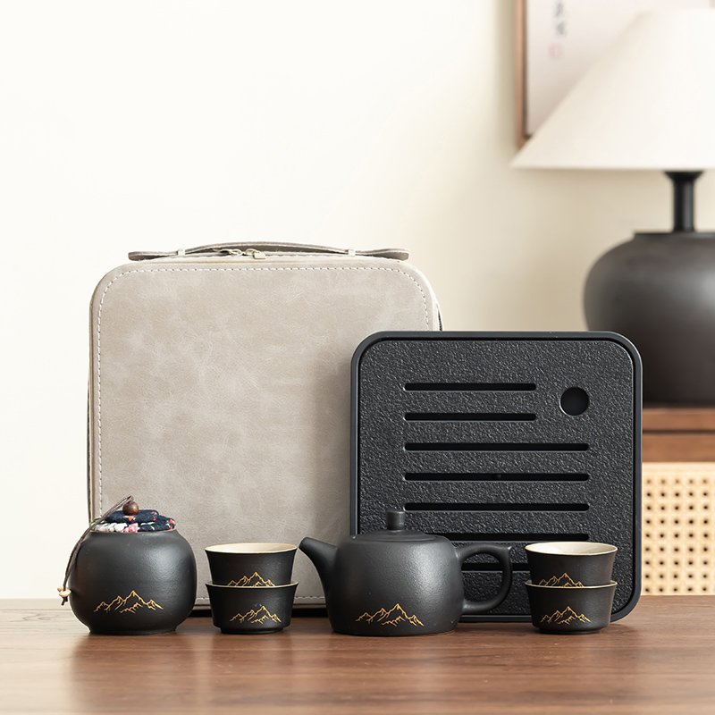 Complete black mountain-motif tea set with four cups, a lidded teapot, covered tea jar, square tray and cream case