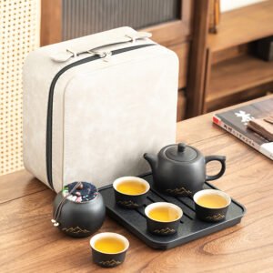 Black ceramic travel tea set with four cups, a mountain-motif teapot, covered jar, square tray and cream case